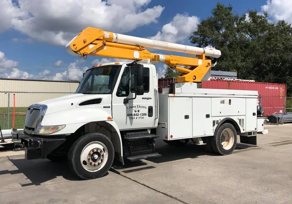 Crown Electric bucket truck with the door lettered Crown Electric, 409-842-1306, TDLR #17720