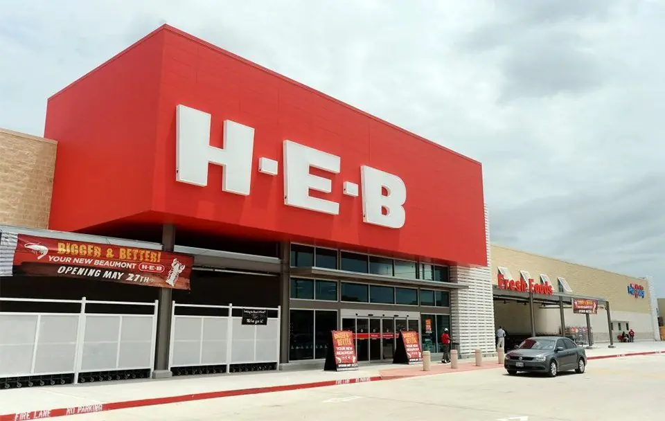A large retail grocery building exterior with facade and car park lighting